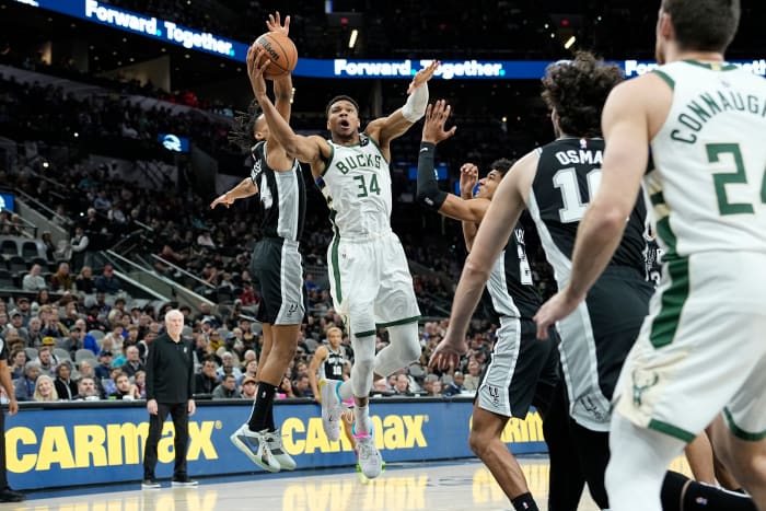 Jan 4, 2024; San Antonio, Texas, USA; Milwaukee Bucks forward Giannis Antetokounmpo (34) between San Antonio Spurs forward Dom Barlow (26) and guard Devin Vassell (24) during the first half at Frost Bank Center.